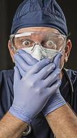 Stunned Doctor or Nurse with Protective Wear and Stethoscope photo