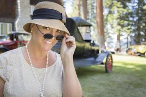 1920s Dressed Girl Near Vintage Car Outdoors Portrait photo