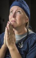 Pleading in Prayer Female Doctor or Nurse photo