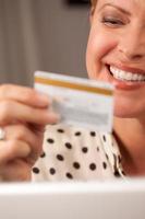 Beautiful Woman Using Laptop Holding Her Credit Card photo