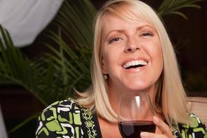 hermosa mujer rubia disfrutando del vino foto