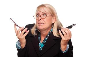 Frustrated Woman with Two Cell Phones photo