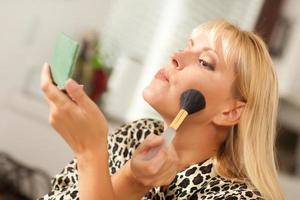 Blonde Woman Applying Her Makeup photo