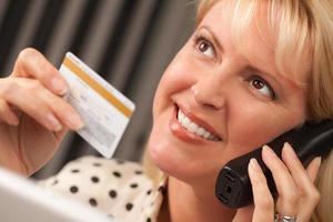 Beautiful Woman on Phone Holding Credit Card photo