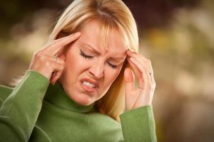 Grimacing Woman Suffering a Headache photo