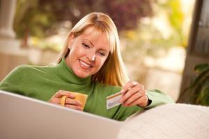 Beautiful Woman with Credit Card Using Laptop photo