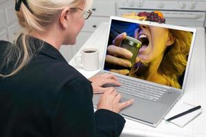 Woman In Kitchen Using Laptop - Entertainment photo