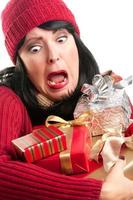 Excited Woman Balancing Holiday Gifts photo