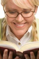 Female With Ponytails Reads Her Book photo