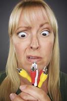 Confused Woman Holding Electronic Cables photo