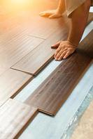 Man Installing New Laminate Wood Flooring photo