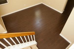 Newly Installed Brown Laminate Flooring and Baseboards in Home photo