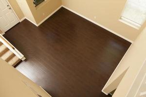 Newly Installed Brown Laminate Flooring and Baseboards in Home photo