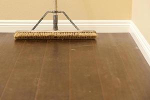 Push Broom on a Newly Installed Laminate Floor and Baseboard photo