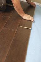 Man Installing New Laminate Wood Flooring photo