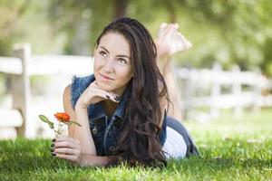 Attractive Mixed Race Girl Portrait Laying in Grass photo