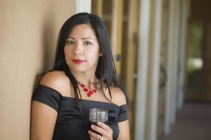 Attractive Hispanic Woman Portrait Outside Enjoying Wine photo