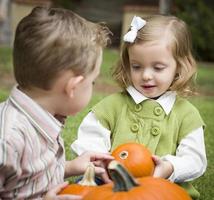 Cute Young Brother and Sister At the Pumpkin Patch photo