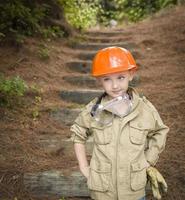 Adorable Child Boy with Big Gloves Playing Handyman Outside photo