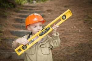 Adorable Child Boy with Level Playing Handyman Outside photo