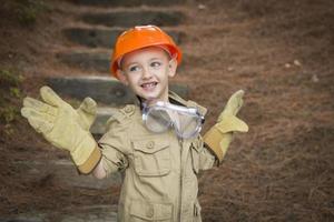 Adorable Child Boy with Big Gloves Playing Handyman Outside photo