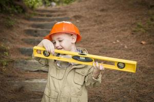 Adorable Child Boy with Level Playing Handyman Outside photo