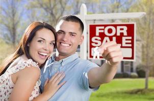 Military Couple In Front of Home, House Keys and Sign photo