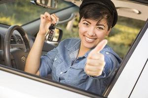 Happy Mixed Race Woman in Car Holding Keys photo