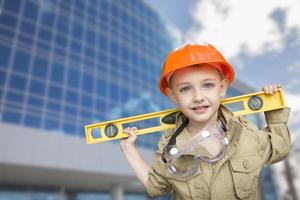 Child Boy Dressed Up as Handyman in Front of Building photo