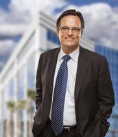 Handsome Businessman Smiling in Front of Building photo