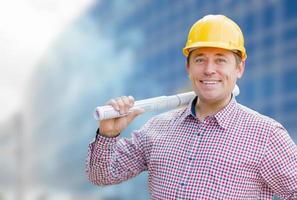 Male Contractor with Hard Hat In Front of Building photo