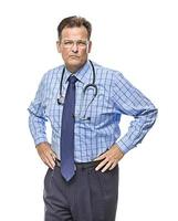Serious Male Doctor with Stethoscope on White photo