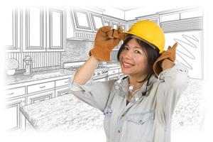 Hispanic Woman in Hard Hat with Kitchen Drawing Behind photo