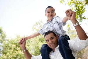 Hispanic Father and Son Having Fun in the Park photo