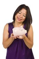 Smiling Hispanic Woman Holding Piggy Bank on White photo