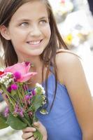 Pretty Young Girl Holding Flower Bouquet at the Market photo