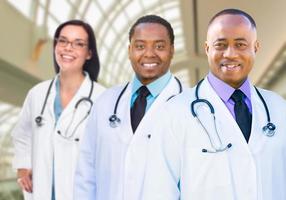 Female and Male Caucasian and African American Doctors in Hospital photo