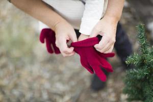 Mother Putting Red Mittens On Child photo