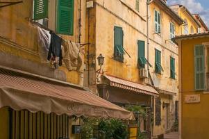 Buildings With Shutters Along Narrow Street in France. photo