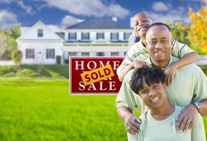 African American Family In Front of Sold Sign and House photo