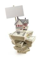 Small House on Stacks of Hundred Dollar Bills and Blank Sign photo