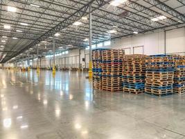 Massive Empty Industrial Warehouse Interior With Stacked Pallets photo