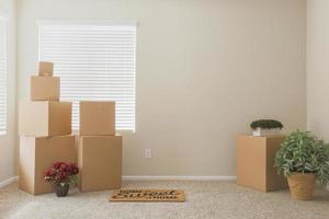 Variety of Packed Moving Boxes In Empty Room photo