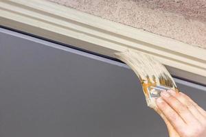 Professional Painter Cutting In With Brush to Paint House Door Frame. photo