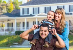 Happy Mixed Race Young Family in Front of House photo