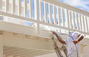 House Painter Spray Painting A Deck of A Home photo