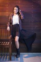 Mixed Race Young Adult Woman Portrait Against Wooden Wall photo