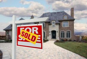 Sold Home For Sale Sign in Front of New House photo