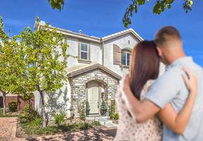 Military Couple Looking at Nice New House photo