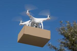 Unmanned Aircraft System UAV Quadcopter Drone Delivering Package photo